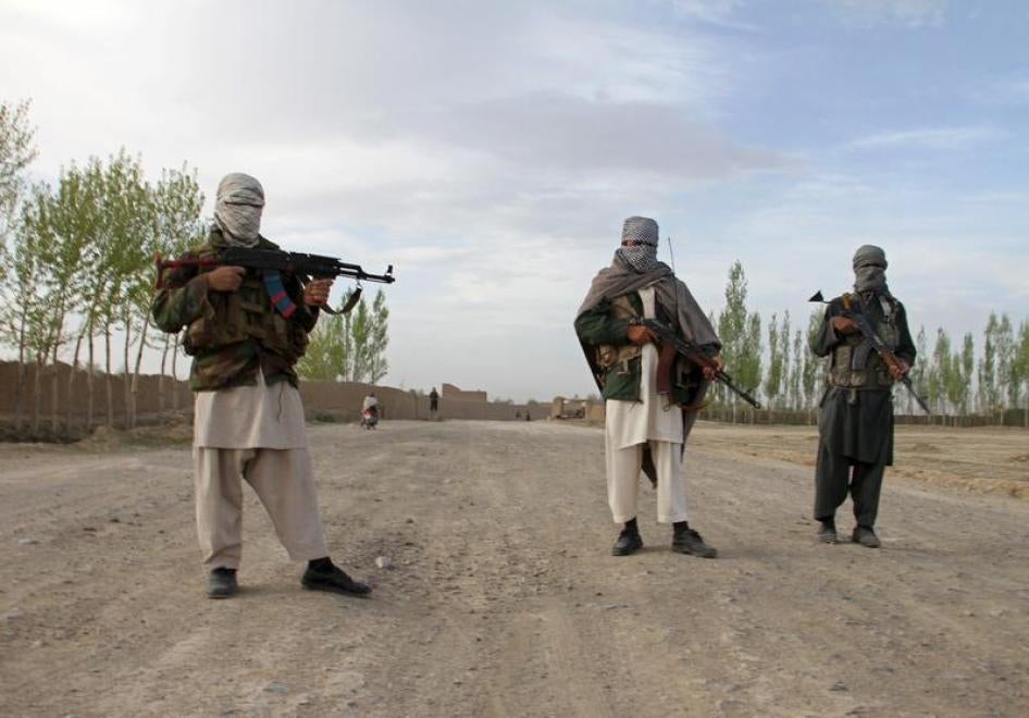 Members of the Taliban stand at the site of the execution of three men in Ghazni Province April 18, 2015.