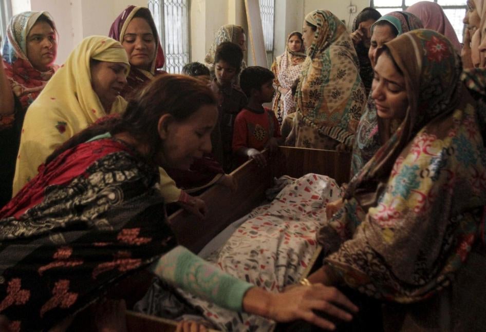 Family members mourn the death of a relative, who was killed in the public park bombing on Sunday, in Lahore on March 28, 2016. 