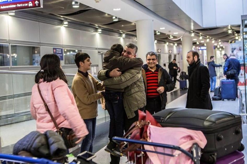 Mohammed meets his children and his wife in Dusseldorf airport, Germany, almost two years after he decided to come to Europe as a refugee. © 2017 Anna Pantelia