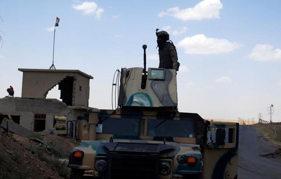 A member of Iraqi security forces stands on the turret of an armoured vehicle along a highway near west of Mosul, Iraq, June 22, 2017. 