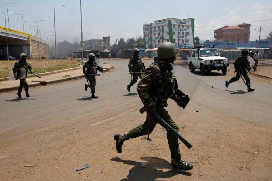 Policemen chase protesters in Kisumu, Kenya August 11, 2017.