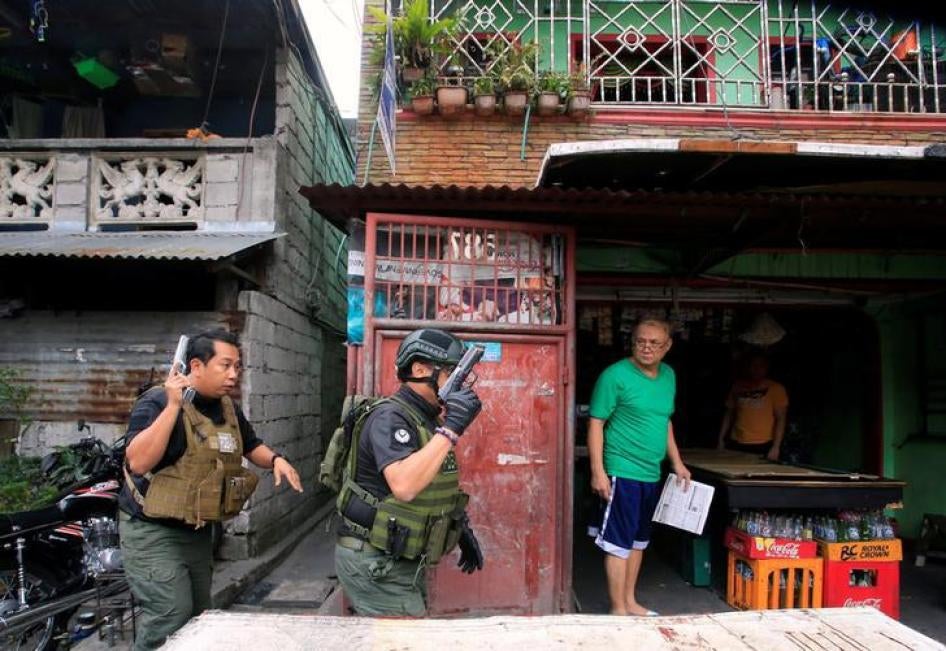 201712asia_philippines_pdea A resident looks at the Philippine Drug Enforcement Agency (PDEA) operatives during their anti-drug operations in Quezon city, metro Manila, Philippines March 16, 2017. 