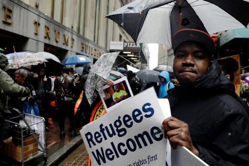 Demonstrators march outside the Trump Building at 40 Wall St. as part of a protest against the US government's refugee ban in New York on March 28, 2017. © 2017 Reuters