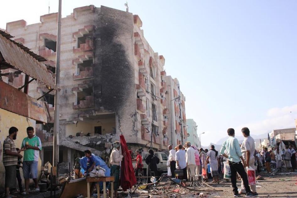 People gather at the site of a car bomb attack outside the Finance Ministry offices in the southern port city of Aden, Yemen November 29, 2017. 