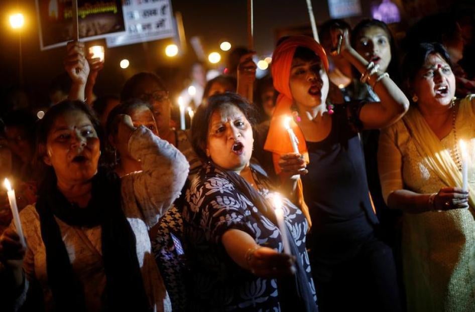 Women hold candles as they shout slogans during a protest against the rape of a ten-year-old girl, in the outskirts of Delhi, India April 25, 2018. 