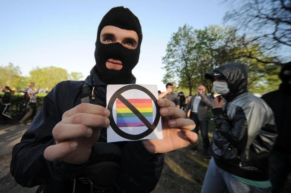An anti-gay rights activist shows a badge during a flash mob organized by gay rights protesters in St. Petersburg May 17, 2012.