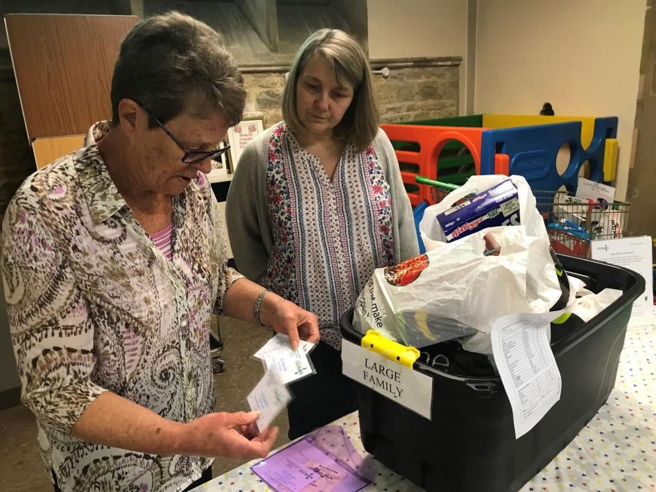 Volunteers at the Wisbech food bank, Cambridgeshire make up an emergency parcel suitable for a large family, April 20. This food bank can sometimes offer families with children an additional £5 voucher to be redeemed at the local butcher or greengrocers. 