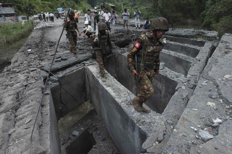 Soldiers walk over the Goktwin bridge, damaged by an explosion, in Nawnghkio, northern Shan State, Myanmar, August 15, 2019.