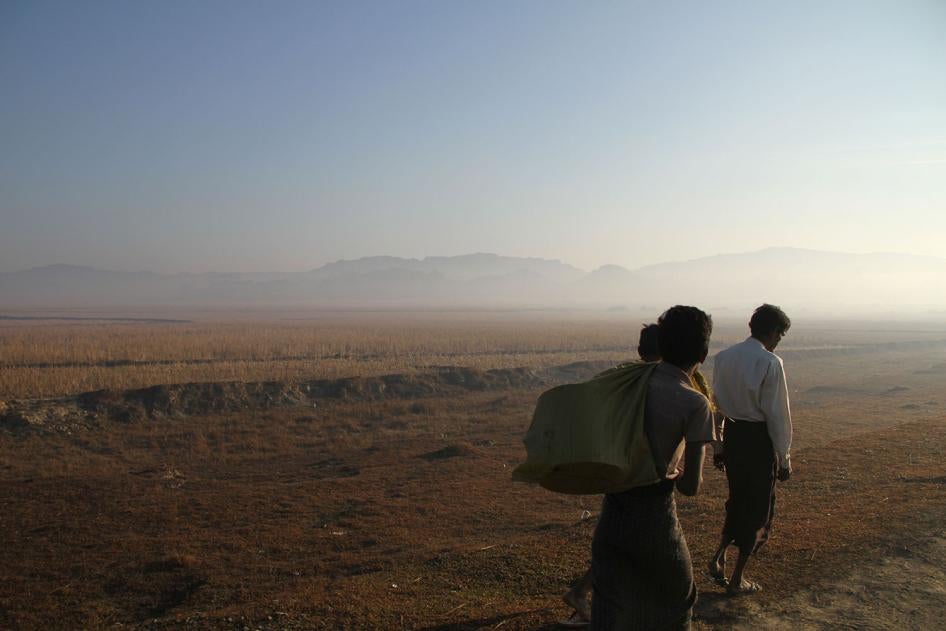 Three people walk along a road close to the surge of fighting between the Arakan Army and Myanmar military in Rakhine State, January 25, 2019.