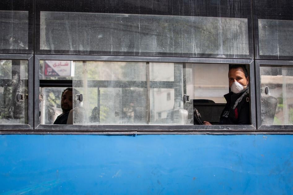 A man wearing a face mask rides in an almost empty bus in Cairo, Egypt, March 30, 2020.