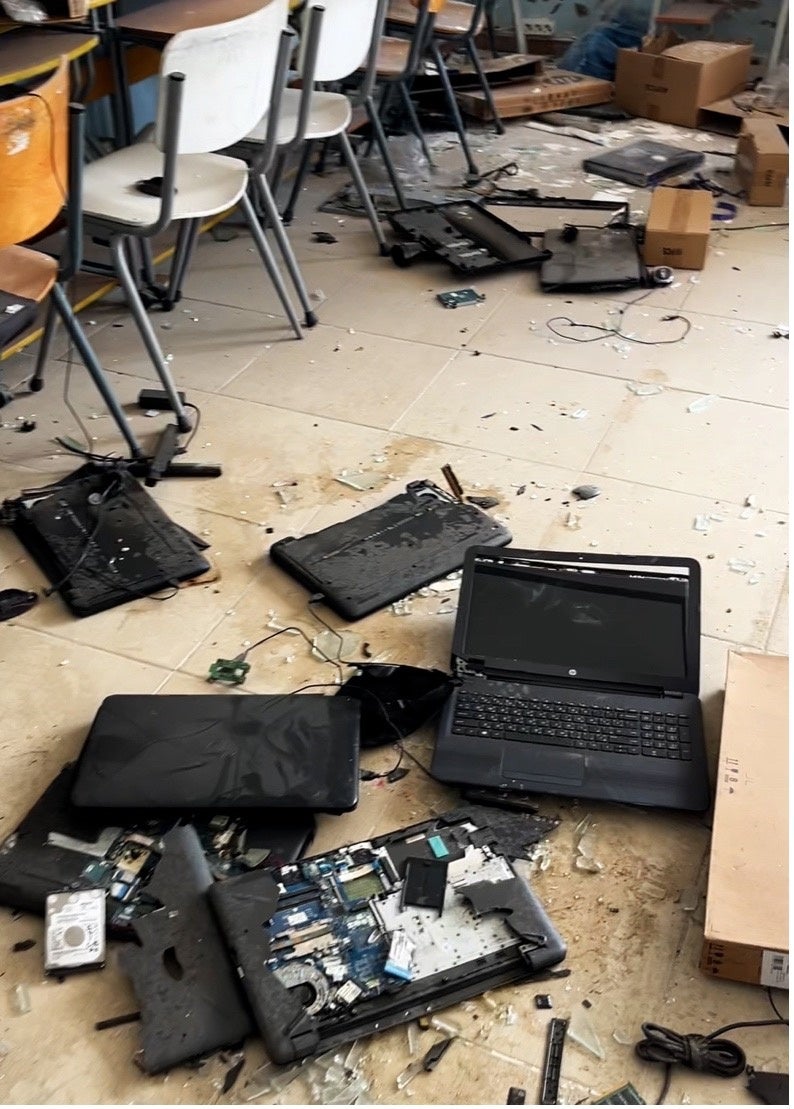Damaged school laptops scattered across the floor of a classroom at Naqoura Intermediate Public School, Lebanon, January 31, 2025.