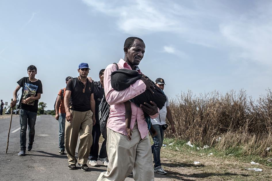 Refugees and asylum seekers arrive at a transit camp in Hungary, after crossing the border from Serbia on September 3, 2015. 
