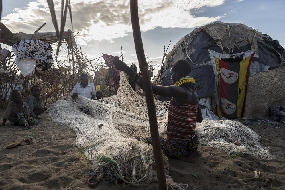 A woman fixes fishing nets