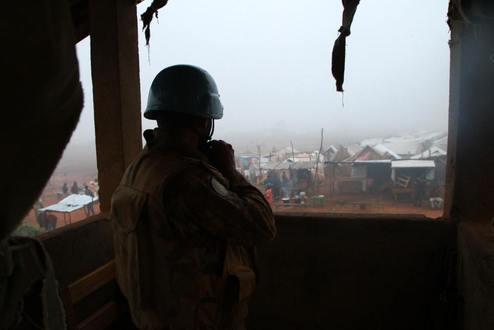 A United Nations peacekeeper in Kaga-Bandoro, Central African Republic, looks out over the new displacement camp near the airstrip that formed after the October 12 attack.  