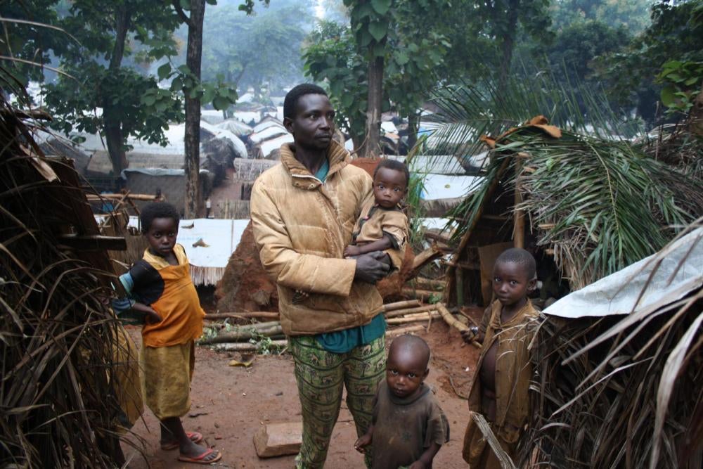 A man from the Paris-Congo neighborhood of Alindao, Basse-Kotto province, Central African Republic, with his children at the displacement camp in town, August 27, 2017. 