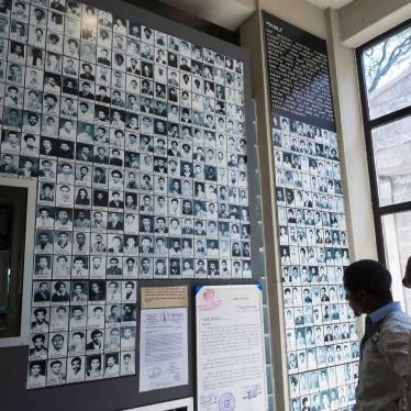Visitors view photos of victims of the Derg regime in Ethiopia's Red Terror Martyrs' Memorial Museum in Addis Ababa on March 4, 2014. © 2014 Eitan Simanor/Alamy Stock Photo.  