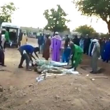 Family and community members in Fada N’Gourma bury 12 men allegedly killed after being detained by gendarmes on May 11, 2020.  © Private 2020.