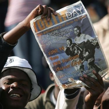 FILE: A South African youth holds a placard during the commemoration of the 30th anniversary of the uprisings in Soweto, South Africa, Friday, June 16, 2006.