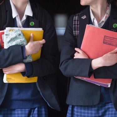 Students walk along a corridor at a school for girls in the U.K. that offers the International Baccalaureate program.