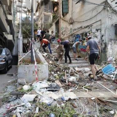 People clean up after a massive explosion in Beirut, Lebanon