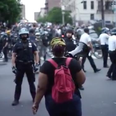 Protester confronted by police line