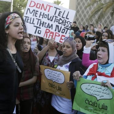 Women chant slogans as they gather to protest sexual harassment in front of the opera house in Cairo on June 14, 2014. 