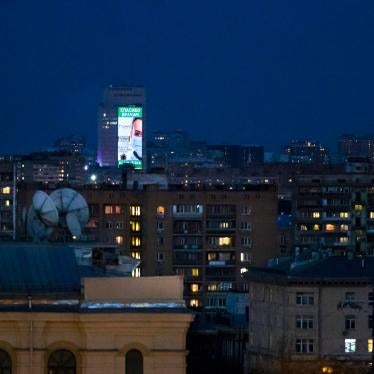 An electronic billboard  is displayed on a office building after sunset in Moscow, Russia, April, 11, 2020. 