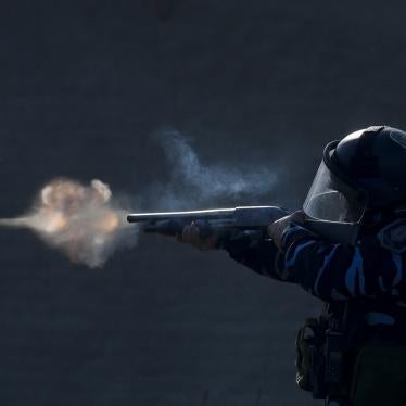 A police officer aims his weapon, as security forces fire tear gas and rubber bullets, during clashes with people after police broke up a squatters camp and evicted people living there in Guernica, Buenos Aires province, Argentina, Thursday, on Oct. 29, 2020.