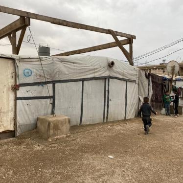 Children play next to shelters in a Syrian refugee camp in Arsal, Lebanon. Around 15,000 Syrian refugees in Arsal are entering their second winter without adequate roofs and insulation since the 2019 directive ordered them to dismantle concrete shelters and rebuild the top portion with tarp and wood. November 2020.