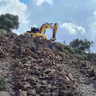 child plays next to an earth digger 