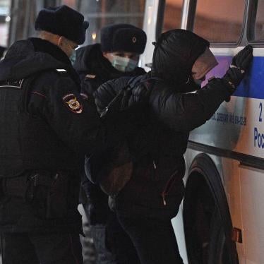 Police officers detaining Alexei Navalny's supporter at Vnukovo airport, Moscow.