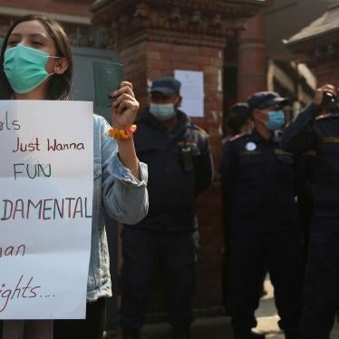 A Nepalese woman holds a placard against a proposed rule which restricts foreign travel for women under 40 years during a protest outside the Department of Immigration in Kathmandu, Nepal, February 11, 2021.
