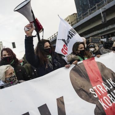 Protesters hold a banner of Strajk Kobiet (Women's Strike) during a protest in Warsaw on March 8,  International Women's Day, organized by the Women's Strike (Strajk Kobiet) against the ruling Law and Justice (PiS) party and the decision of the Constitutional Court.