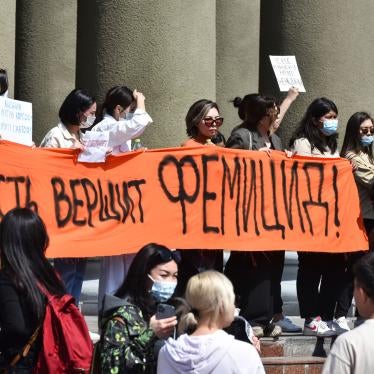 People attend a rally for the protection of women's rights in Bishkek, Kyrgyzstan, protesting the kidnapping and killing of Aizada Kanatbekova, April 8, 2021. The banner reads, "The Authorities are Responsible for Femicide."