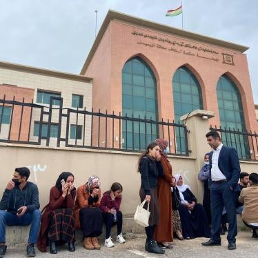 Families of the journalists and activists on trial on February 16, 2021, sitting outside the Erbil District Court of Appeal.