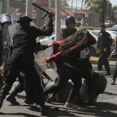 National police officers beat opposition member Valeska Valle and other demonstrators taking part in a "National sit-in" protest against President Daniel Ortega's government in Managua on March 30, 2019.