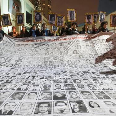 Demonstrators show photos of people killed during Brazil's dictatorship outside a police station that used to be a torture center used by the dictatorship in Sao Paulo, Brazil on August 5th, 2019.
