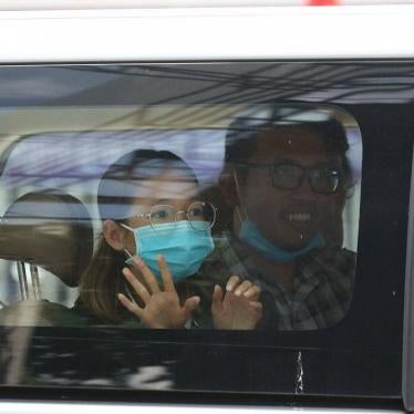 Mother Nature Cambodia activist Sun Ratha waves to her family as she is brought to the Phnom Penh Municipal Court on June 19, 2021. (c) 2021 LICADHO