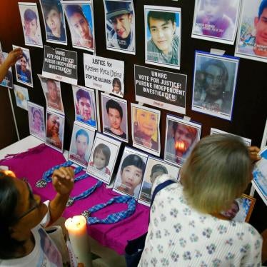 Families of victims of alleged extrajudicial killings in the so-called "war on drugs" with portraits of their slain relatives on July 9, 2019, in Manila, Philippines.