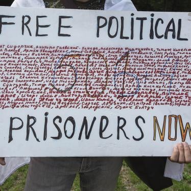 In The Hague, Netherlands, on August 7, a demonstrator holds a placard showing the names of some of those arbitrarily detained in Belarus for protesting against President Alexander Lukashenko, and calling for their release.