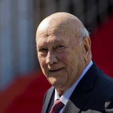 An elderly man smiles at the camera