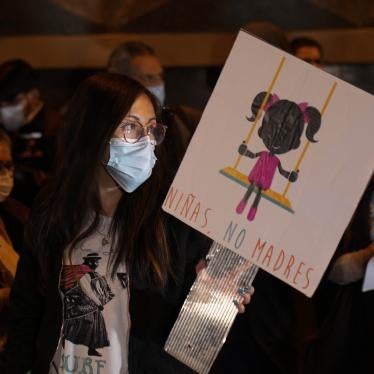 A woman holds a banner that reads in Spanish "Girls, not mothers," during a demonstration calling for sexual and reproductive rights in La Paz, Bolivia, on Oct. 27, 2021. The case of an 11-year-old girl who became pregnant after repeatedly being raped by a family member rekindled the debate on abortion in Bolivia.