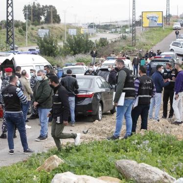 Security forces inspect the scene where Lokman Slim was found shot dead in his car.