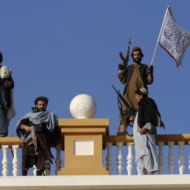 Armed men stand atop a city gate