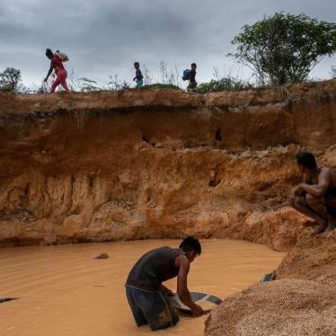 Men look for diamonds and gold in a recently dug mine