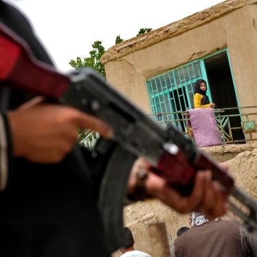 A Taliban fighter stands guard at the site of an explosion in front of a school, in Kabul, Afghanistan, April 19, 2022.