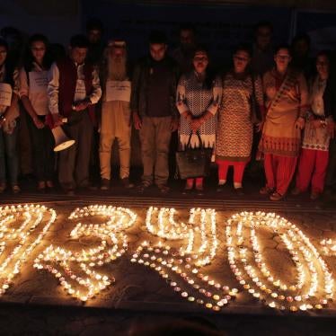 Nepalese human rights activists and relatives of disappeared persons, make a formation with lighted candles that reads 1350+ (referring to the number of victims) at an event to mark the International Day of the Disappeared in Kathmandu, Nepal, August 30, 2017.