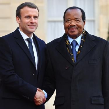 French President Emmanuel Macron greets Cameroon President Paul Biya at the Elysee Palace in Paris, France, on December 12, 2017, as part of the One Planet Summit.