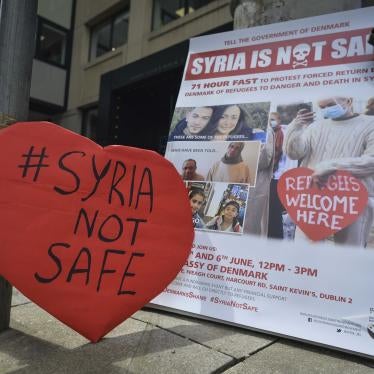 A protest sign that reads "#Syria Not Safe"