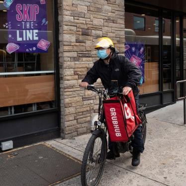 A delivery man bikes with a food bag from Grubhub in New York, April 21, 2021